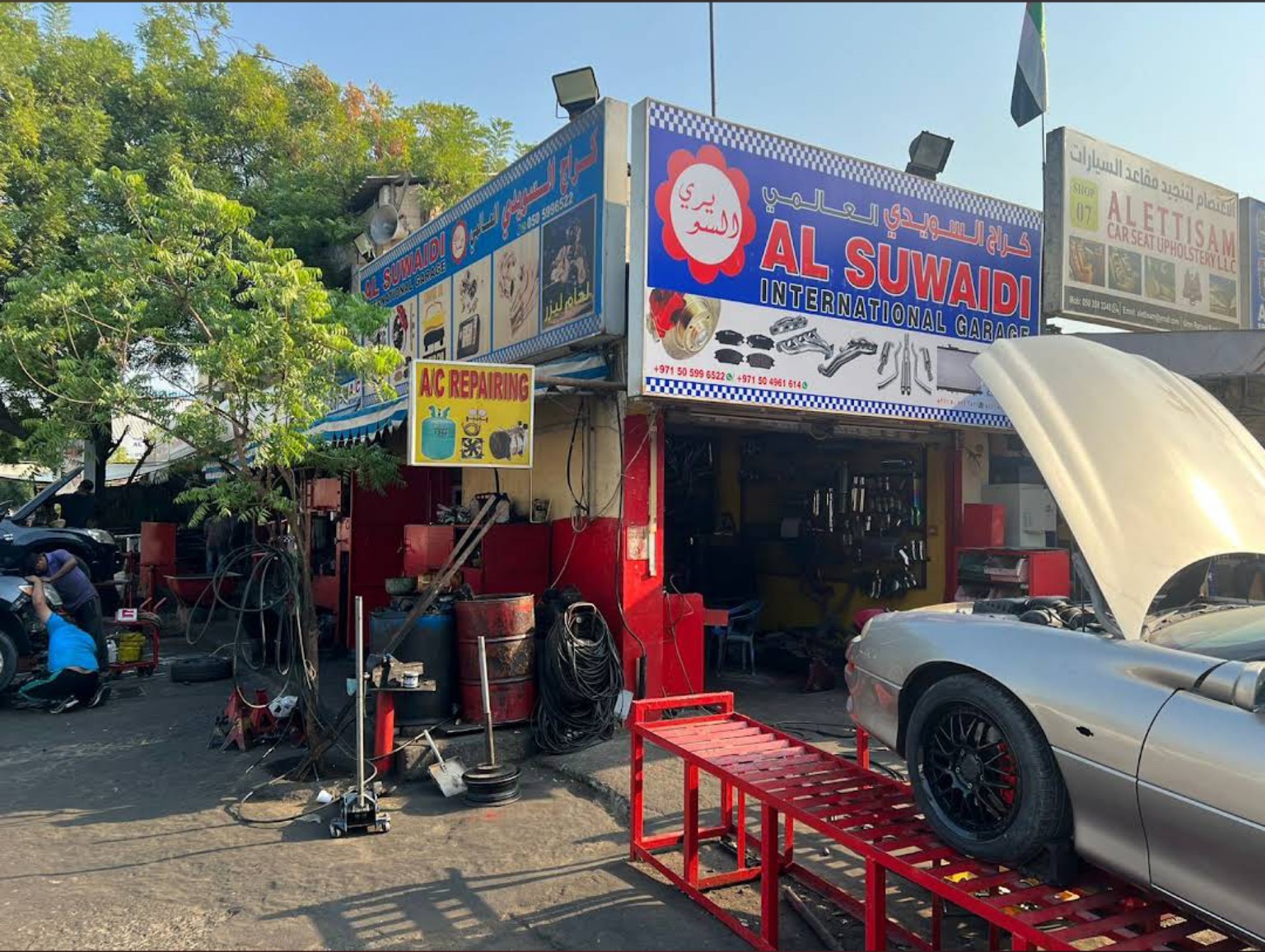 Vehicles being serviced outside the Al Suwaidi International Garage workshop